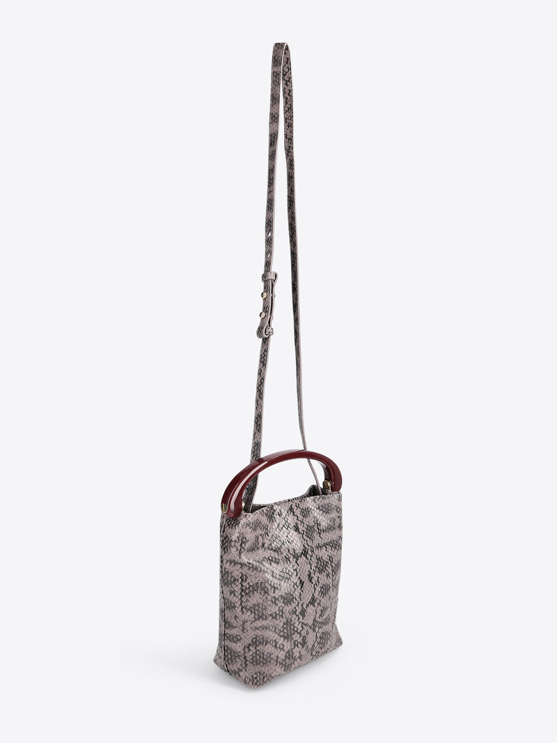 Small handbag with a snake print body and burgundy handle on a white background