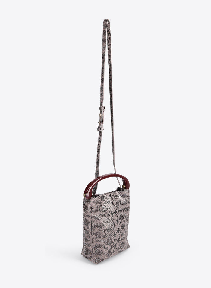 Small handbag with a snake print body and burgundy handle on a white background