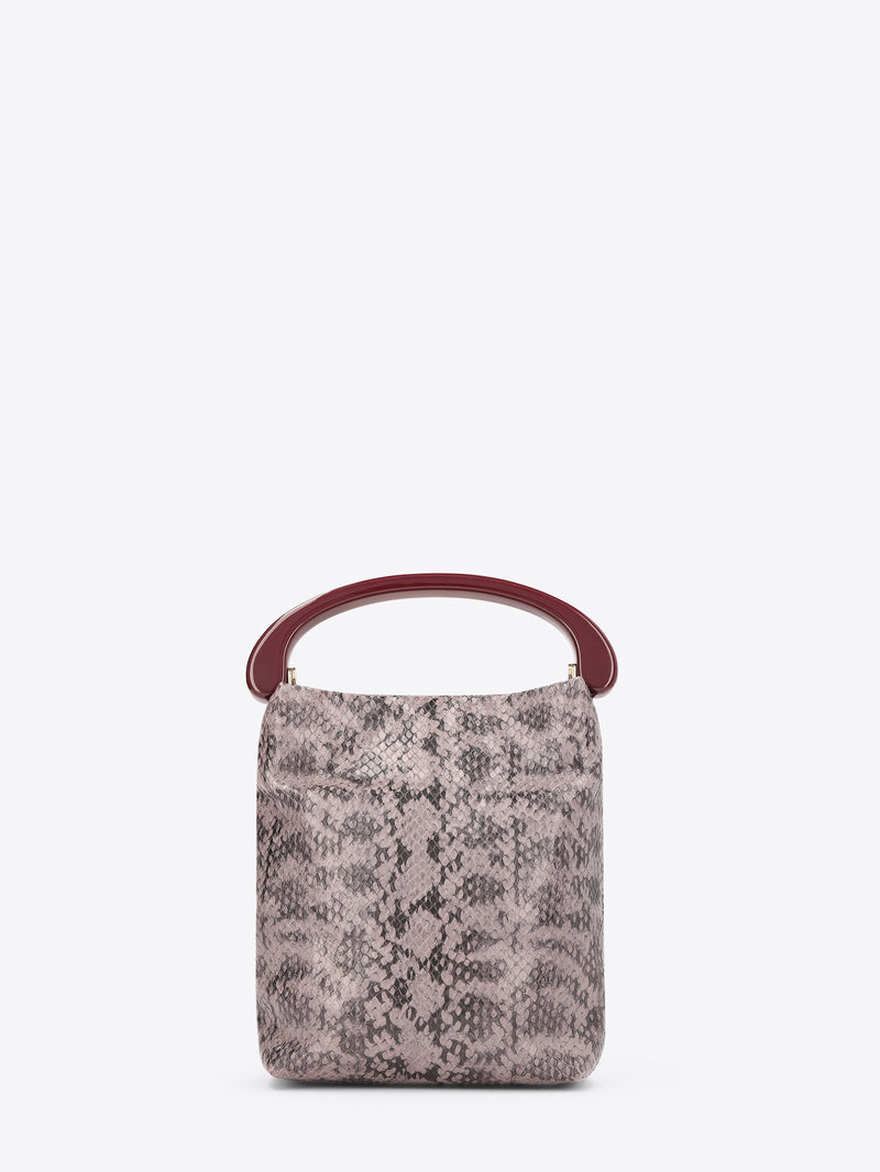 A snake print handbag with a burgundy handle on a white background
