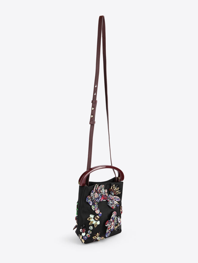 Floral embroidered handbag with a strap on a white background