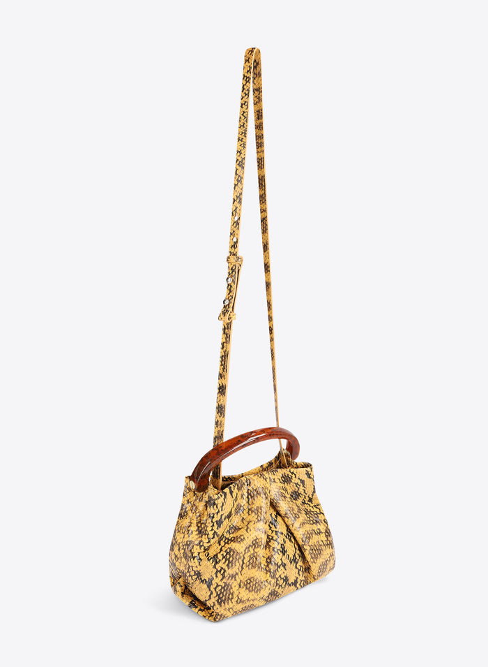 Yellow patterned handbag with a brown handle on a white background