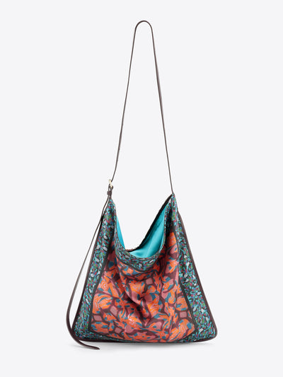 Multicolored bag with a strap on a light grey background