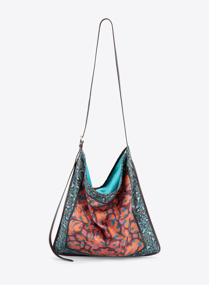 Multicolored bag with a strap on a light grey background