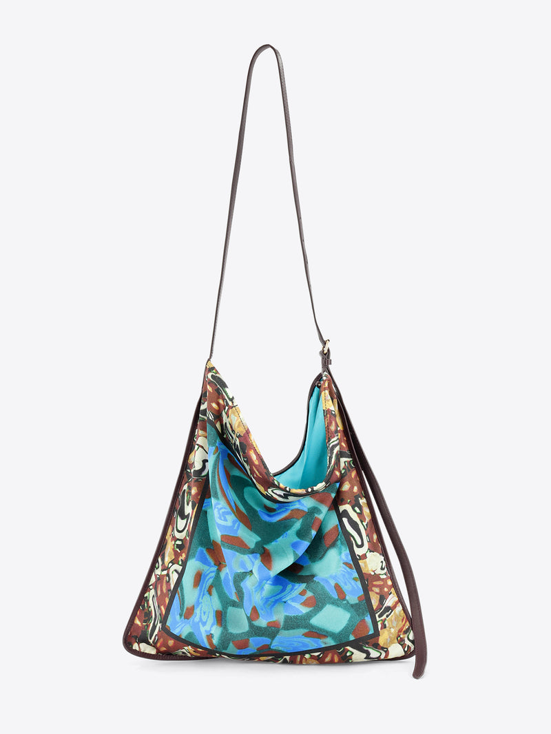 Multicolored patterned handbag on a light grey background