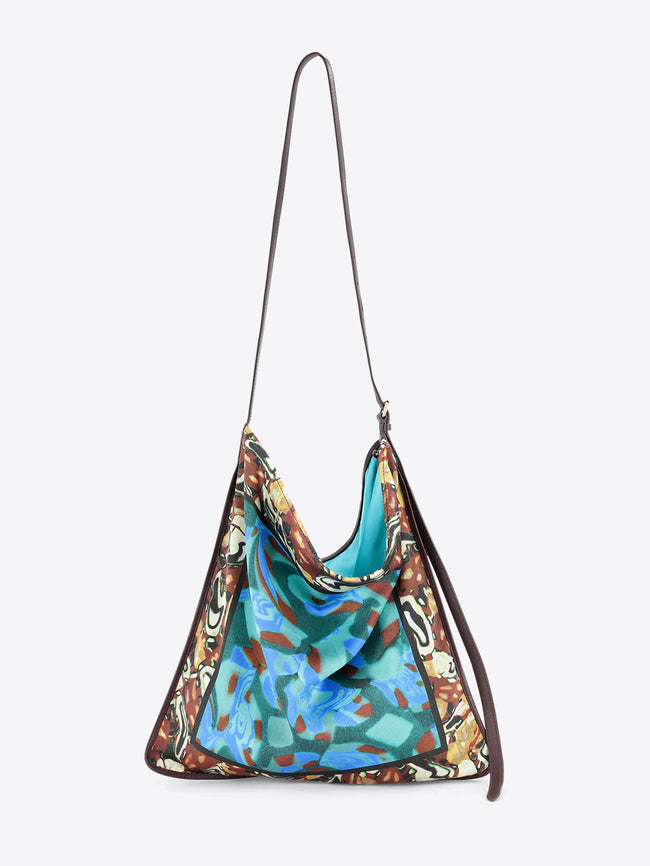 Multicolored patterned handbag on a light grey background