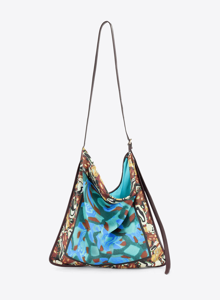 Multicolored patterned handbag on a light grey background