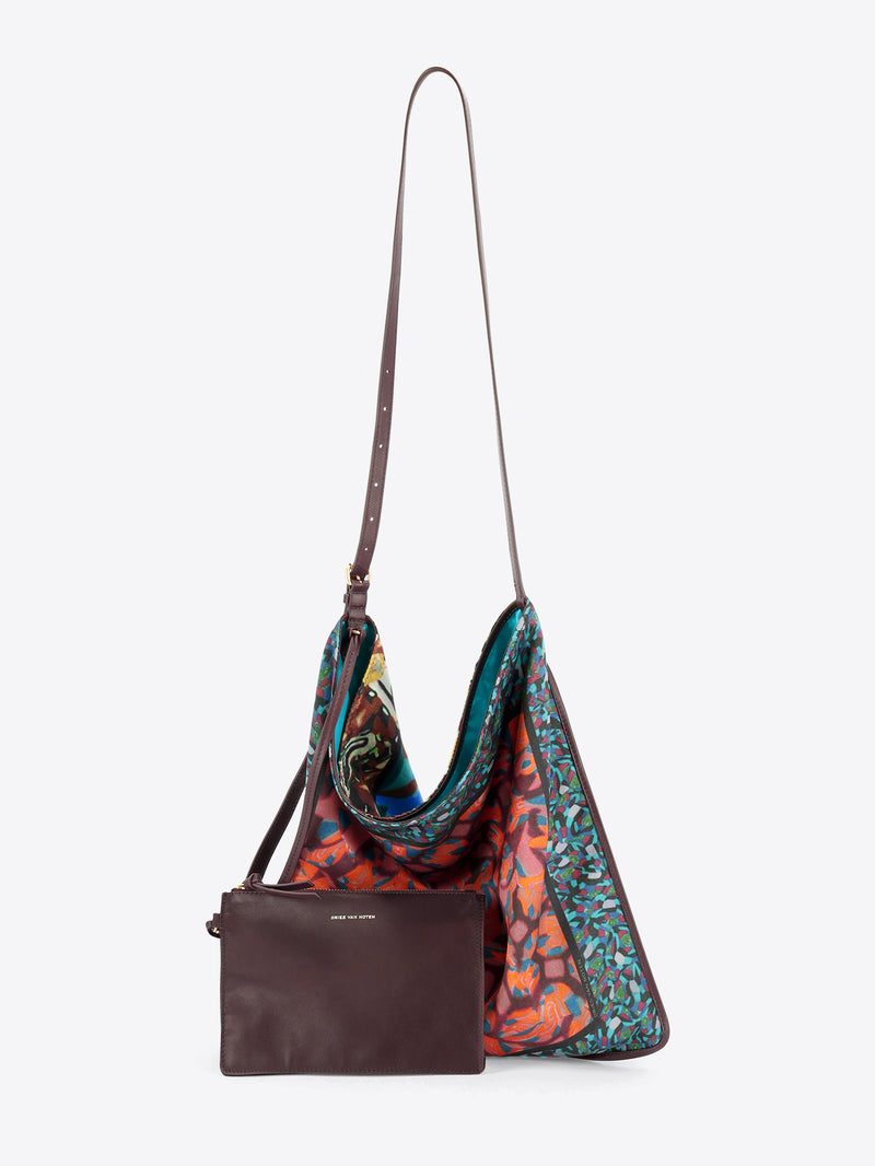 Floral hobo bag with matching crossbody pouch hanging against a light grey background 