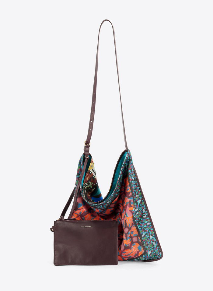 Floral hobo bag with matching crossbody pouch hanging against a light grey background 