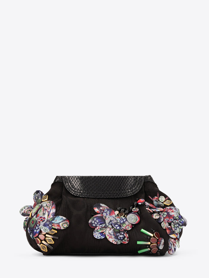 Black handbag with colorful floral embellishments on a white background