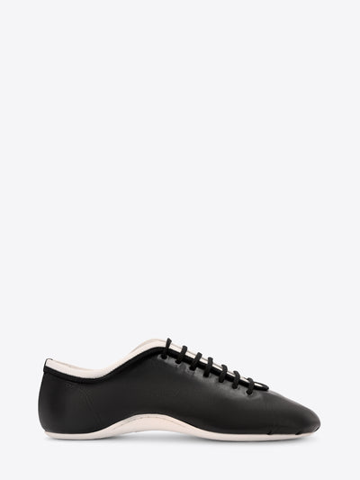 Black sneaker with white sole on a white background