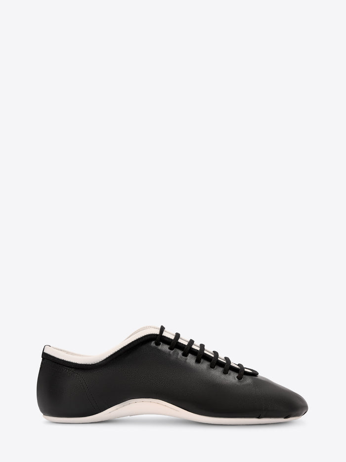 Black sneaker with white sole on a white background