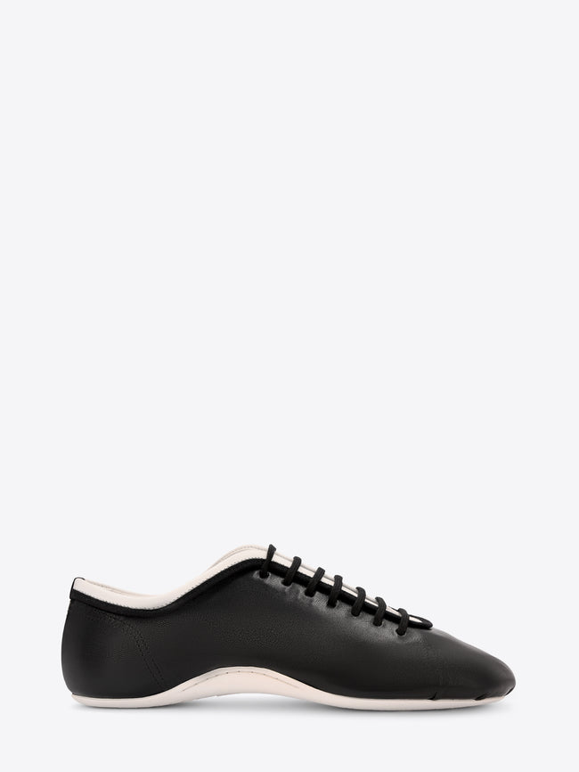Black sneaker with white sole on a white background