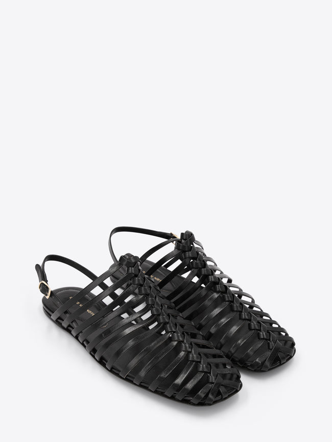 Black strappy sandals on a white background