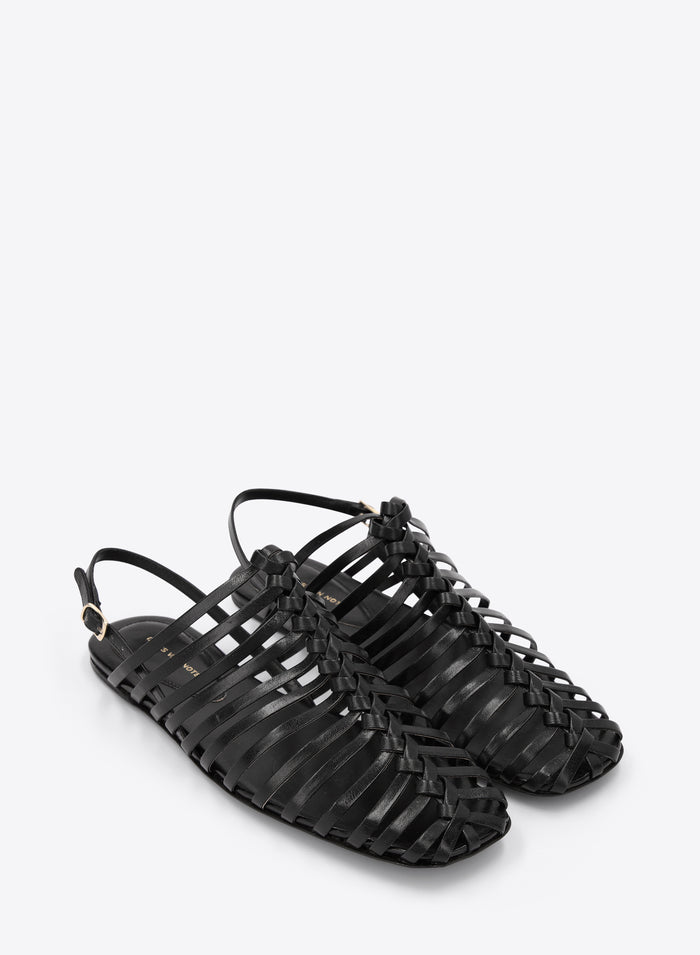 Black strappy sandals on a white background