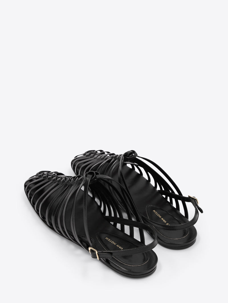 Black strappy sandals on a white background