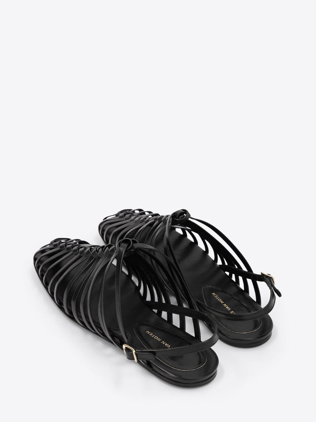 Black strappy sandals on a white background