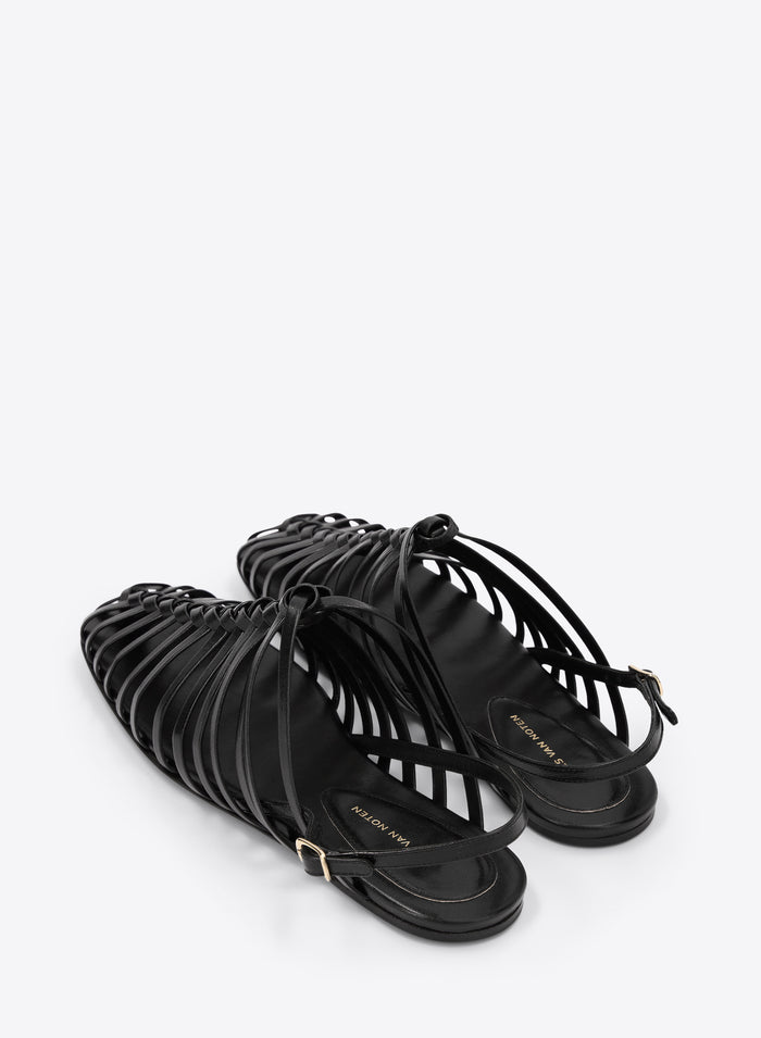 Black strappy sandals on a white background