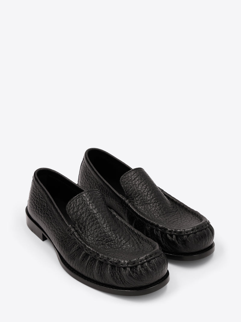 Pair of black loafers on a white background