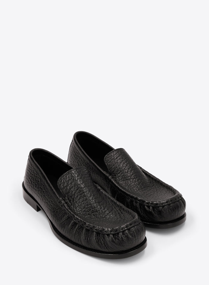 Pair of black loafers on a white background