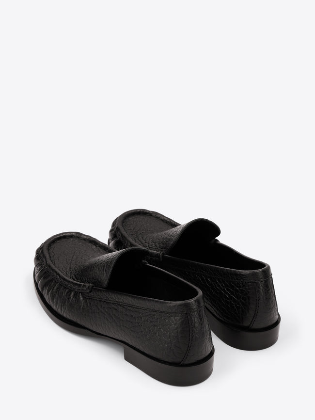 Pair of black loafers on a white background