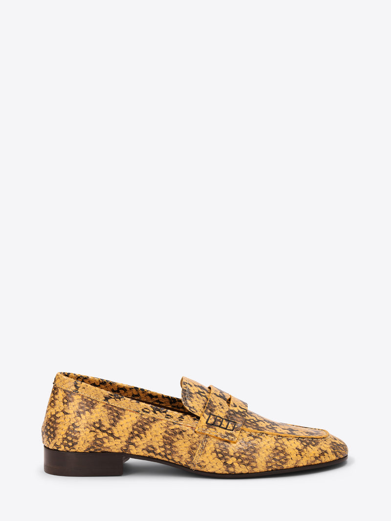 Yellow patterned loafer shoe on a white background