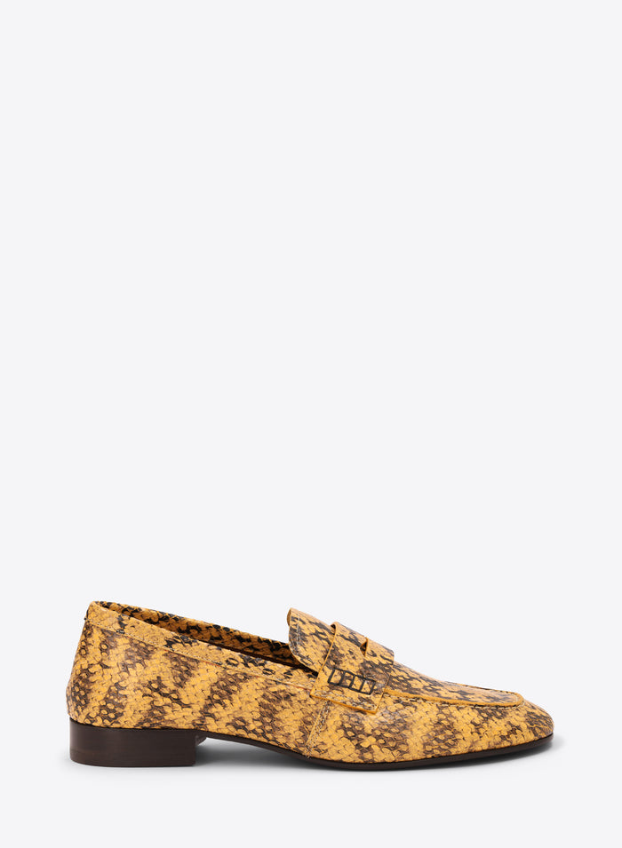Yellow patterned loafer shoe on a white background