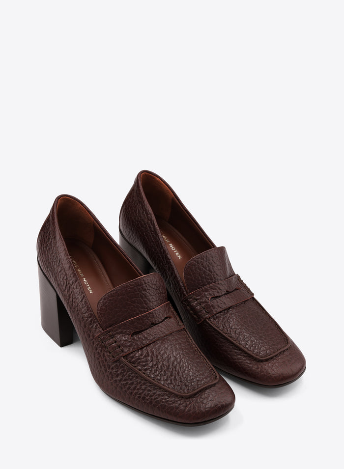 Pair of brown leather loafers with block heels on a white background