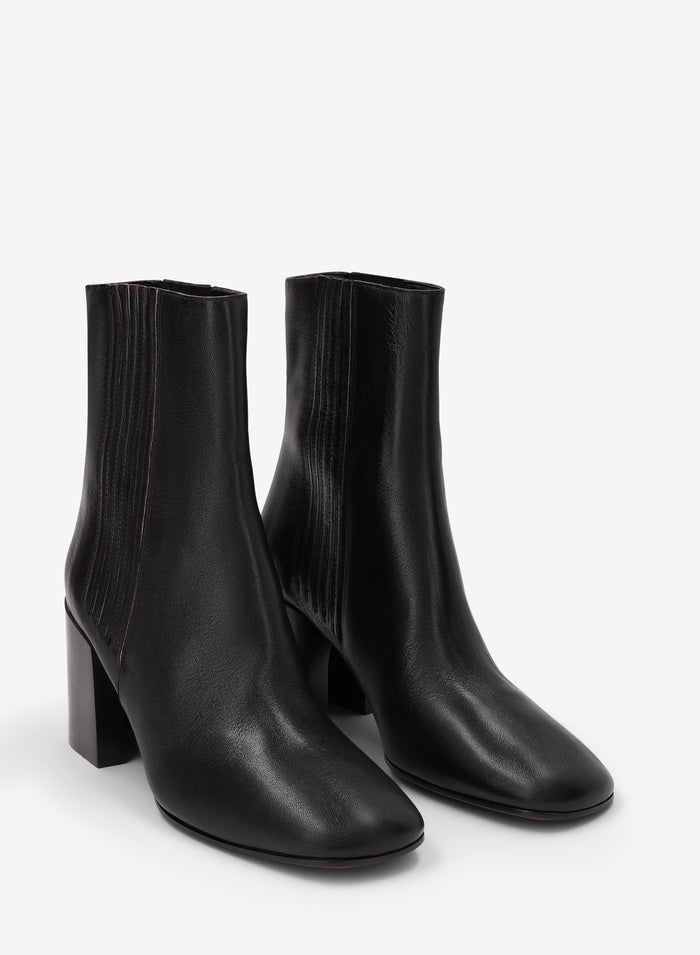 Pair of black ankle boots on a white background