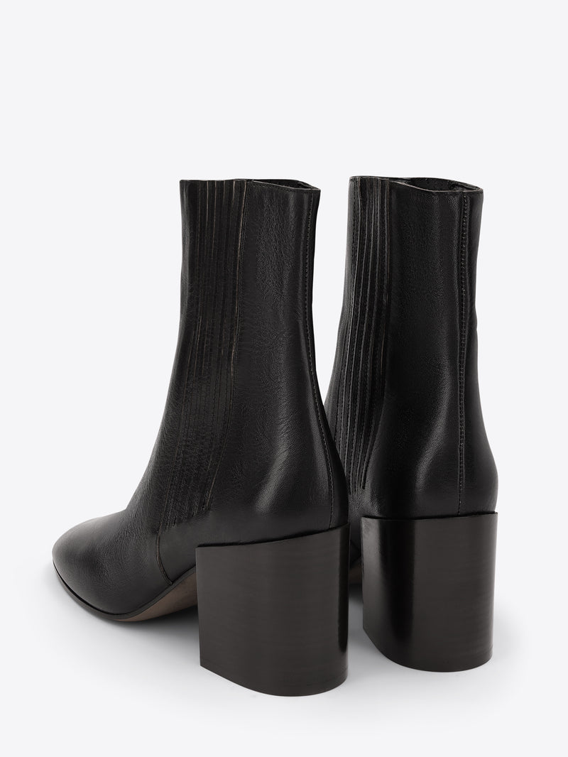 Pair of black ankle boots on a white background