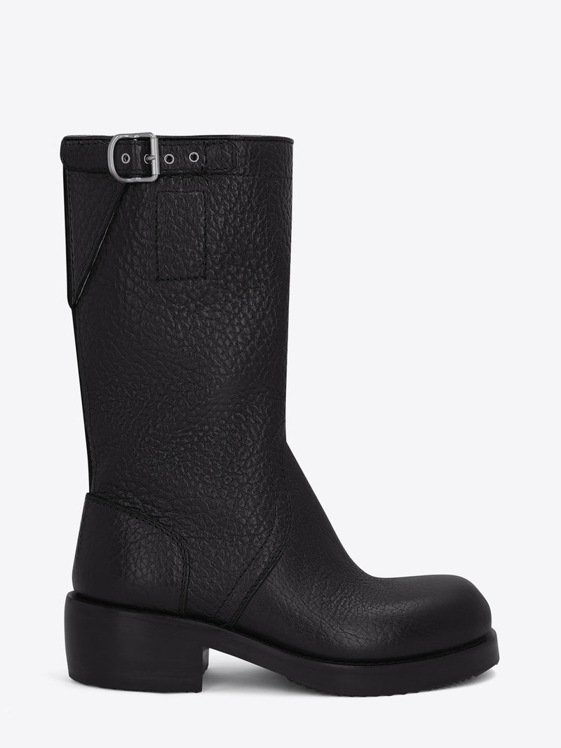 Pair of black leather boots on a light grey background