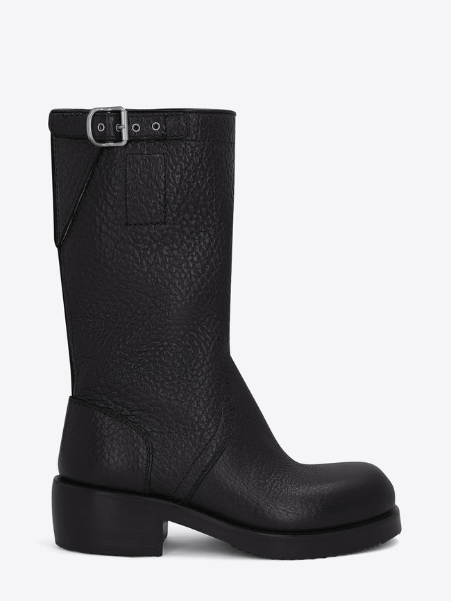 Pair of black leather boots on a light grey background