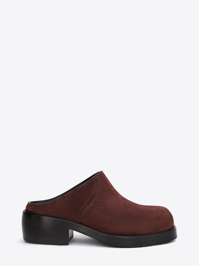 Brown clog shoe on a light grey background