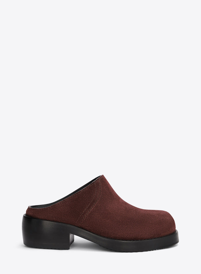 Brown clog shoe on a light grey background