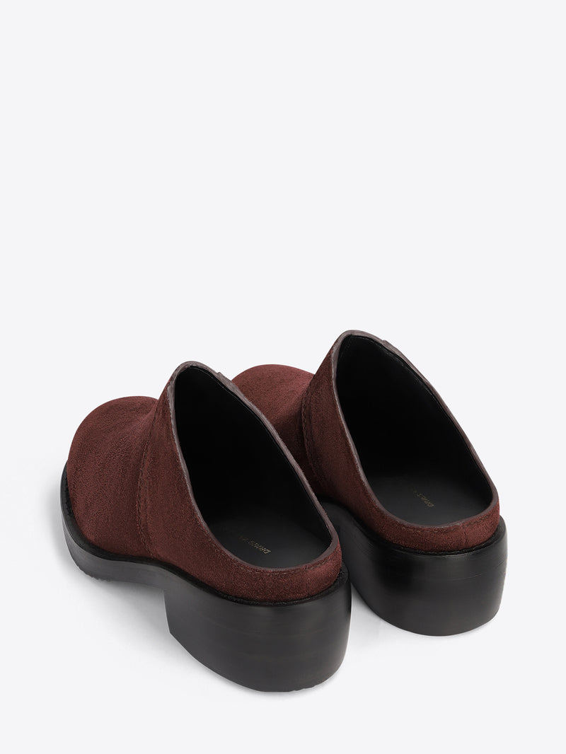 Brown clog shoes on a light grey background