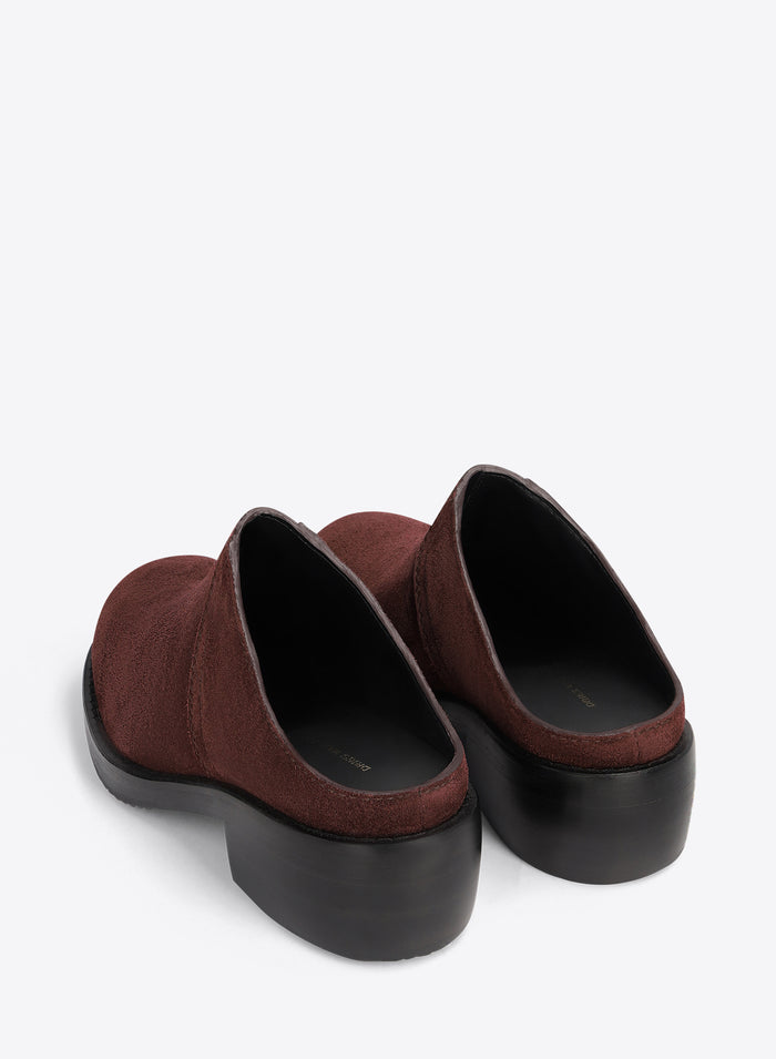 Brown clog shoes on a light grey background