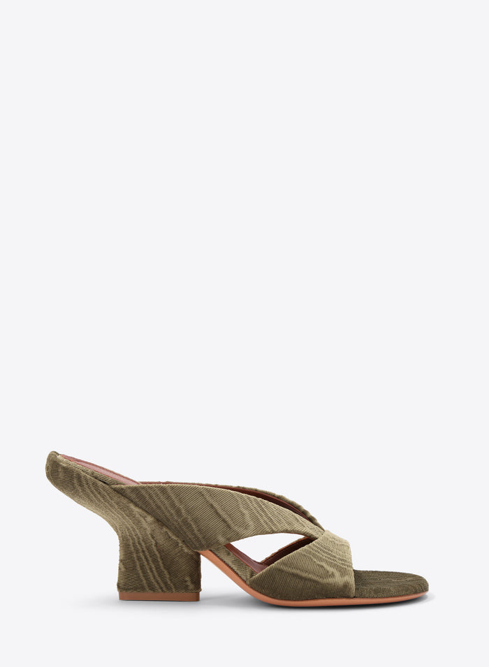 Green mule shoe with a block heel on a white background