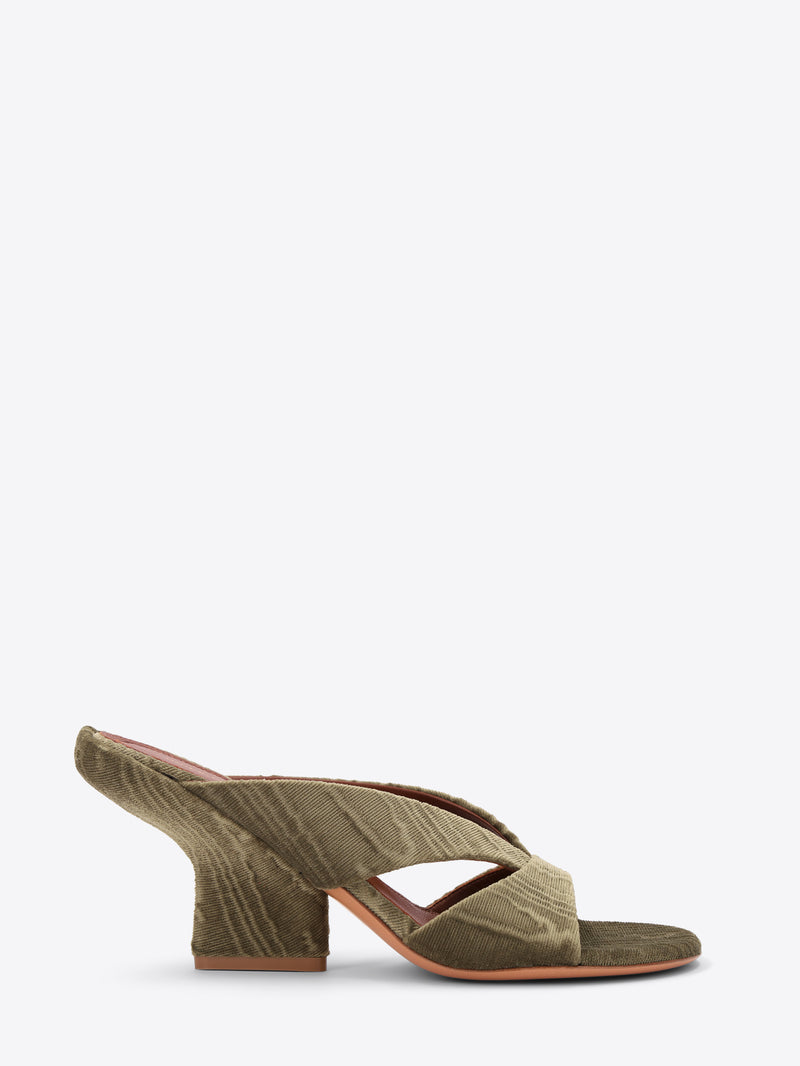 Green mule shoe with a block heel on a white background