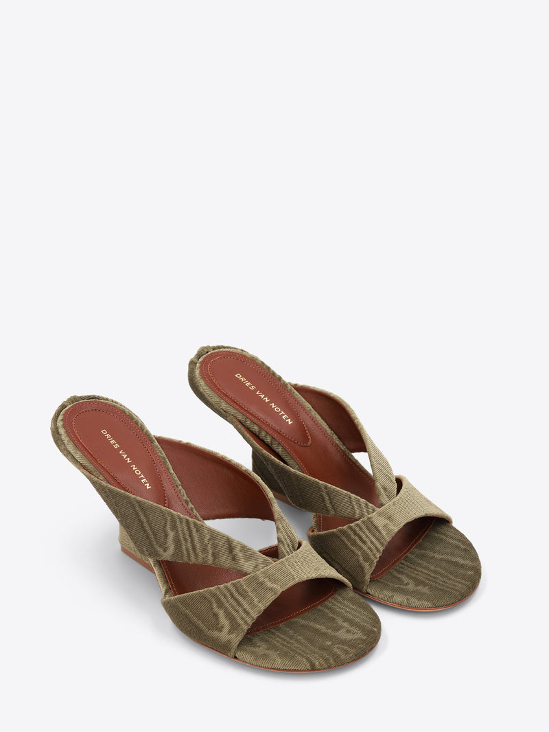 Pair of green mules on a white background