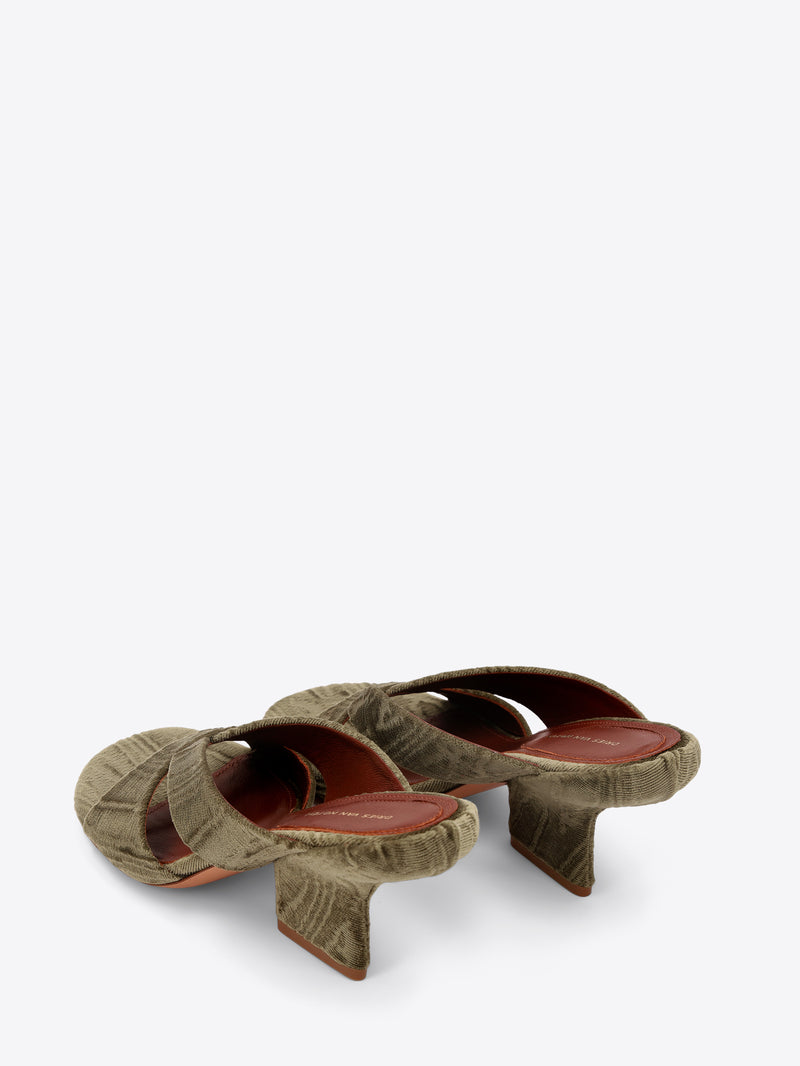 Pair of green mules on a white background