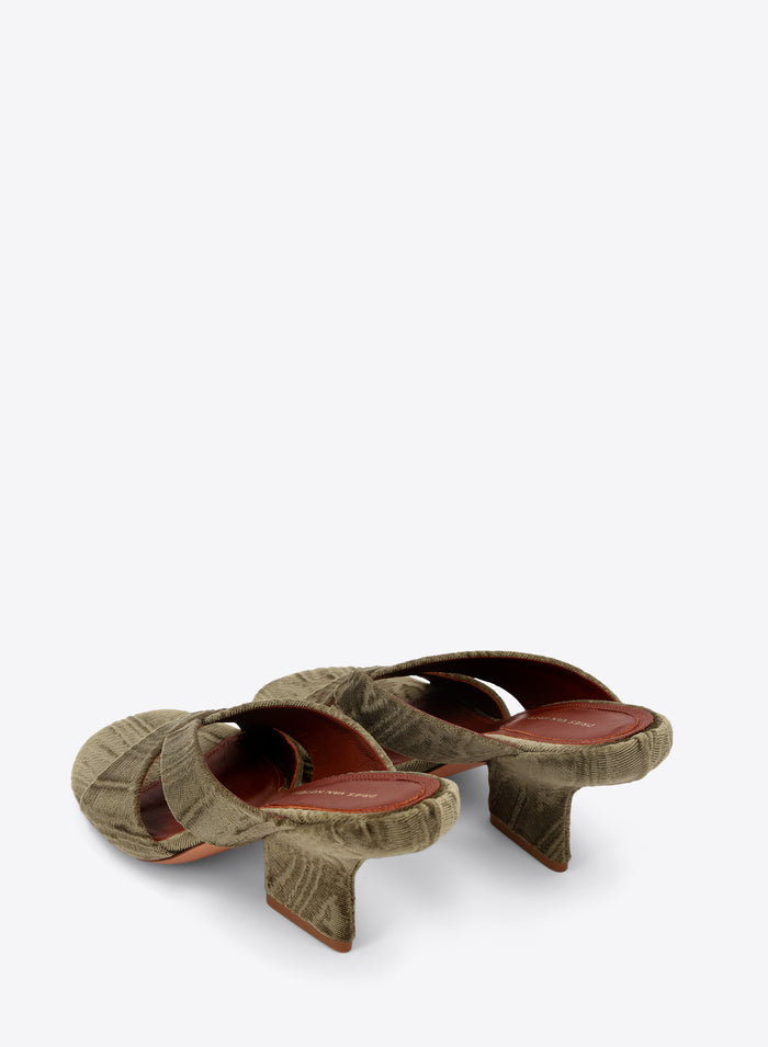Pair of green mules on a white background