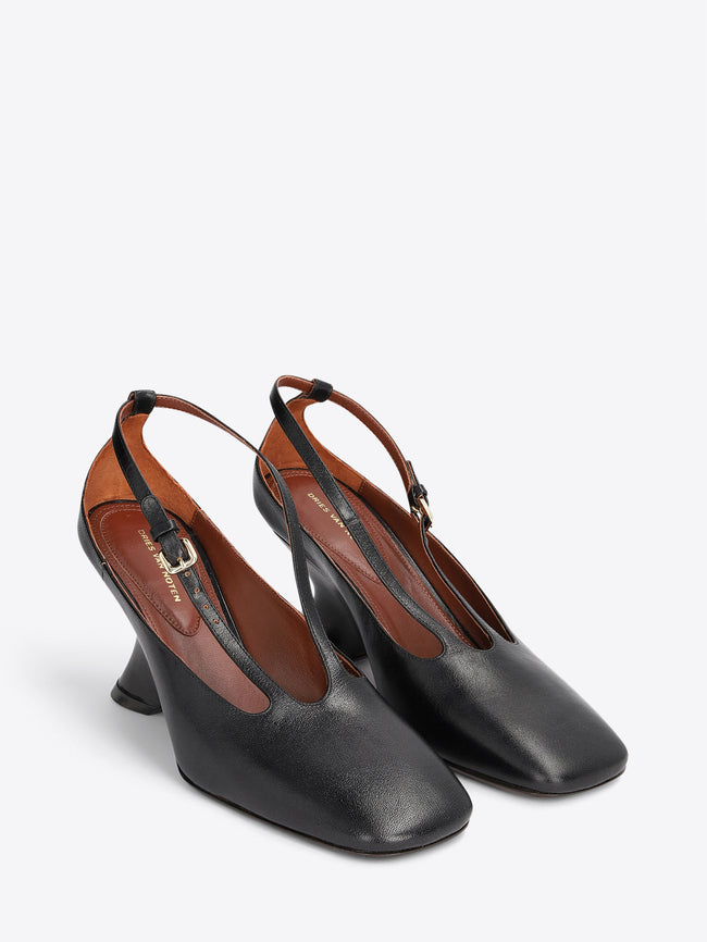 A pair of black leather slingback pumps with a low block heel and a thin strap detail across the instep on a light gray background.