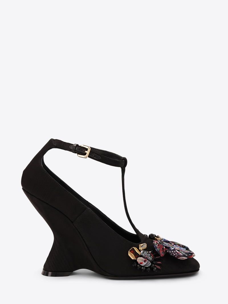 Black heel shoe with floral embroidery on a white background
