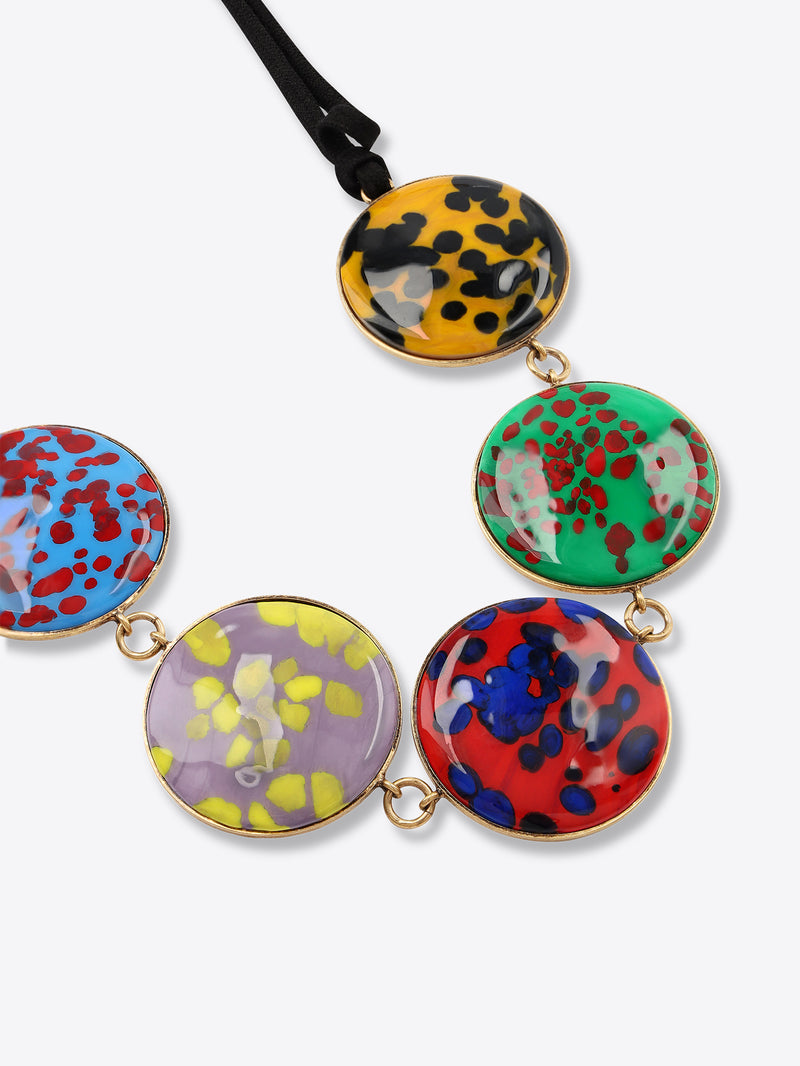 Multicolored circular pendants on a black cord against a white background