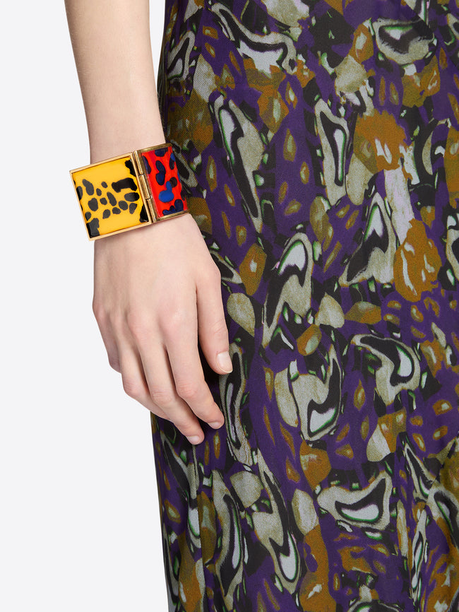Patterned dress with a colorful cuff on a plain background