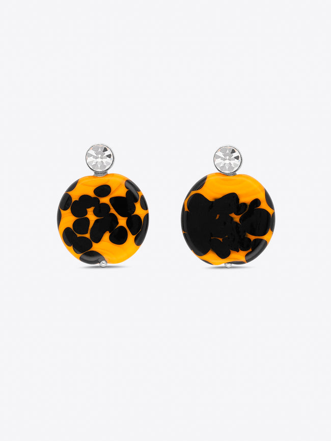 Pair of earrings with black and orange pattern on a white background