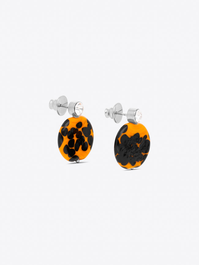 Pair of earrings with black and orange pattern on a white background