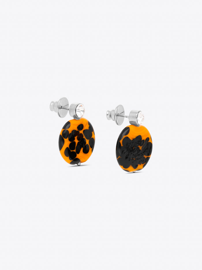 Pair of earrings with black and orange pattern on a white background