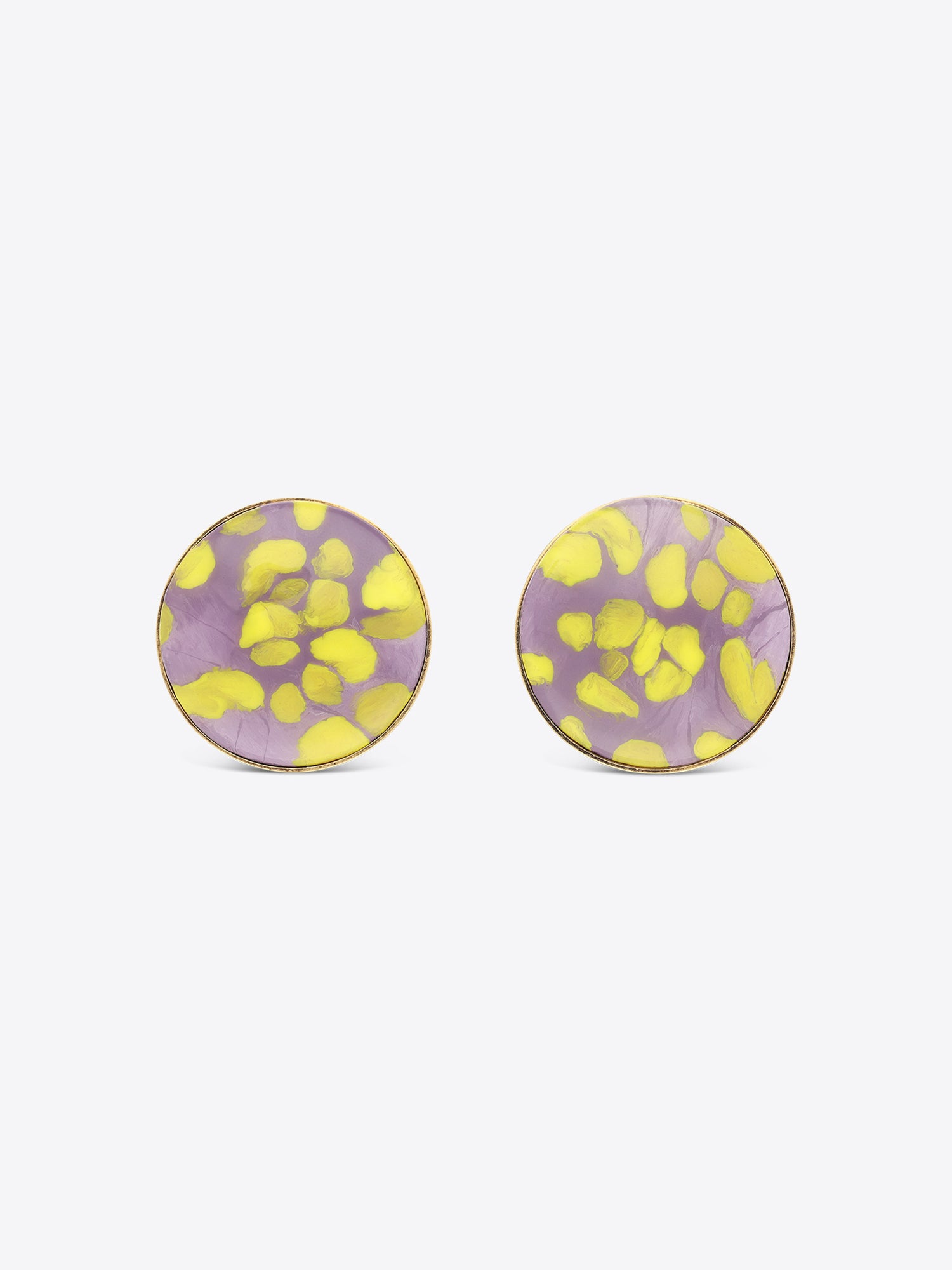 Pair of round earrings with purple and yellow floral pattern on a white background