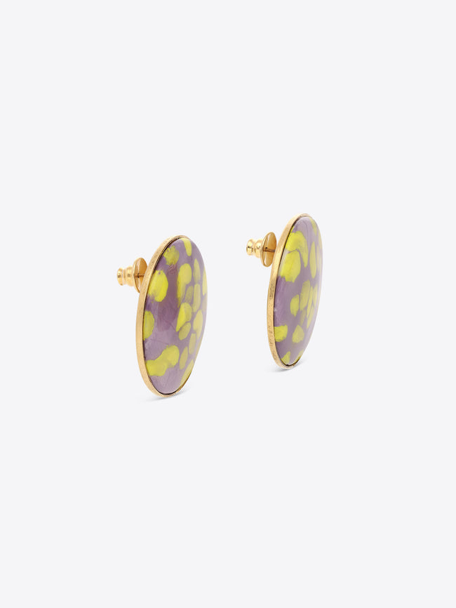 Pair of round earrings with purple and yellow floral pattern on a white background