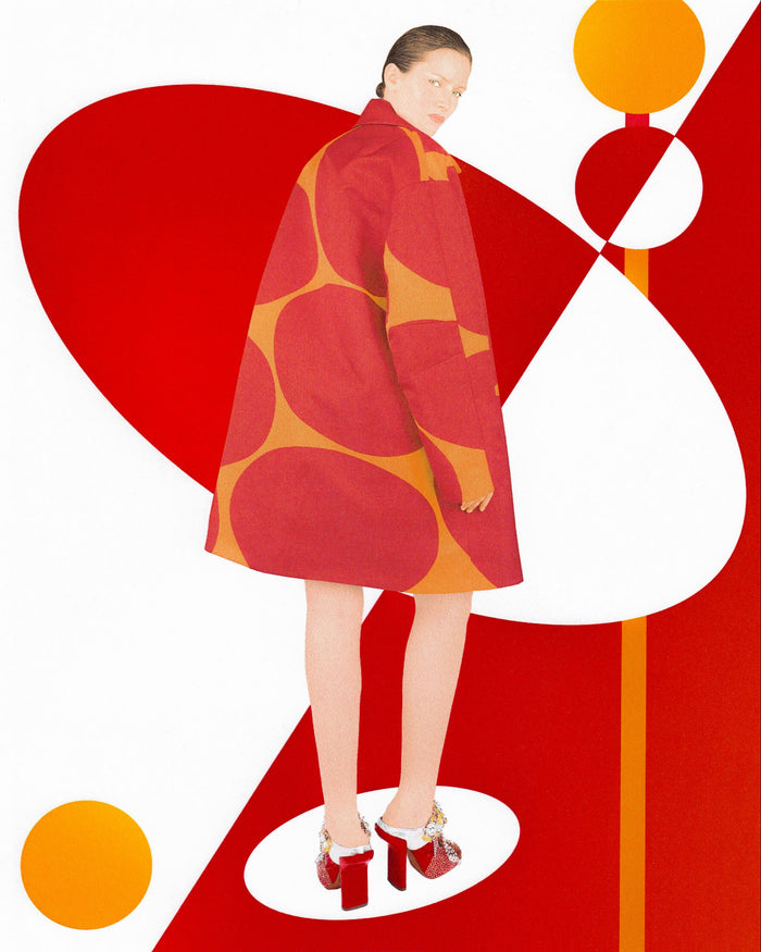 Model wearing a red and orange patterned coat against a graphic background  